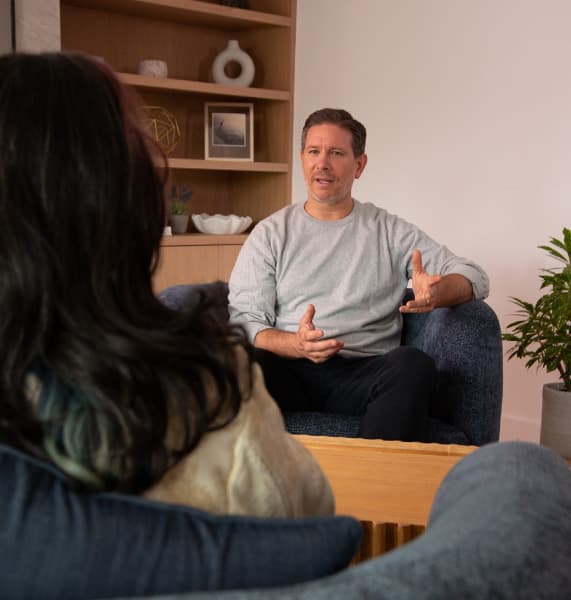 A man is talking to a counsellor.